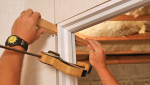 Installing trim and finishing touches to a remodeled basement in Queensbury, NY