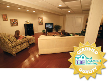 A remodeled basement with the Total Basement Finishing badge