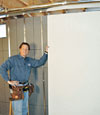 Installing wall panels on top of our basement wall insulation in Ballston Spa