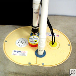 A sump pump system installed along a basement floor in Ionia