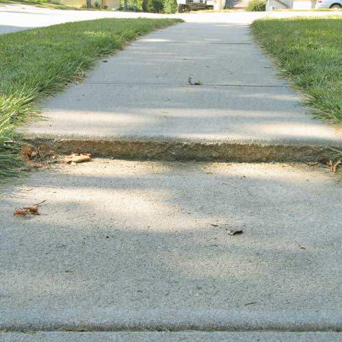 Sidewalk that is uneven and sinking