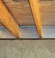 SilverGlo™ insulation installed in a floor joist in Delmar