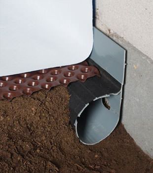 Closeup of a crawl space drainage system installed in Johnstown