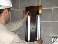 Mounting a foundation wall plate for an earth anchor installation in Amsterdam.