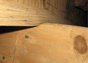 A failing girder showing signs of compression damage in a New York home