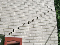 Stair-step cracks showing in a home foundation in Castleton On Hudson