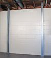 A steel i-beam system installed on a Catskill foundation wall