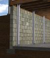 I-beam foundation wall supports installed in a Fort Edward basement.
