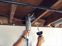 Straightening a foundation wall with the PowerBrace™ i-beam system in a Queensbury home.