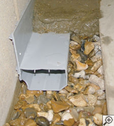 A no-clog basement french drain system installed in Guilderland