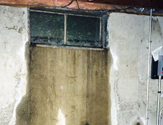 Water pouring out from a basement window in Cohoes